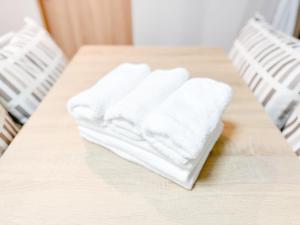 two white towels sitting on top of a table at Apartment Hotel Side of Shinsaibashi Shopping street in Osaka +27 photos
