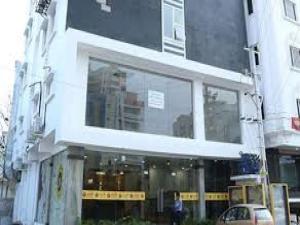 a building with large windows on a city street at La Riviera Suites Madhapur in Hyderabad