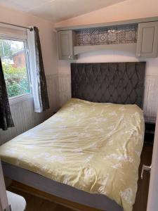 a bed in a small room with a window at Haven caravan park Cala gran in Fleetwood