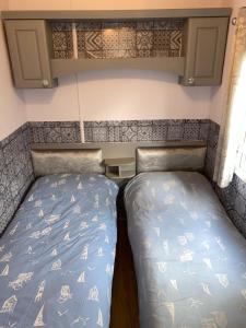 a small room with two beds in a trailer at Haven caravan park Cala gran in Fleetwood