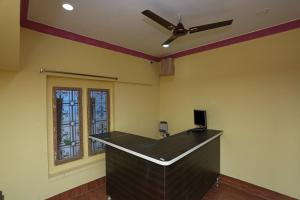 an office with a desk with a ceiling fan at OYO Flagship Moonlight Residency in Bhubaneshwar