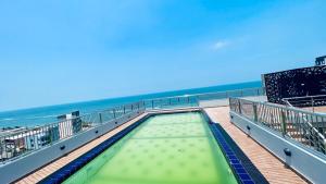 a swimming pool on a pier next to the beach at M8 Apartments in Wellawatte in Colombo