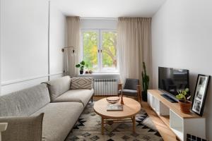 ein Wohnzimmer mit einem Sofa und einem Tisch in der Unterkunft Apartament Szamotulska 59A in Posen