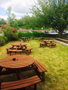 a group of picnic tables in the grass at Markets Tavern Hotel in Brecon