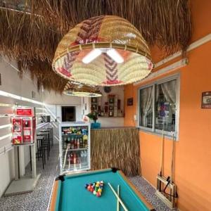 a room with a pool table in a restaurant at Villa Bunmark in Sirindhorn