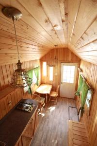 an inside view of a wooden cabin with a table and a room at Waterfront Tiny House near Pomquet Beach in Antigonish