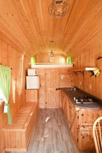 a kitchen in a wooden cabin with a sink and a counter at Waterfront Tiny House near Pomquet Beach in Antigonish