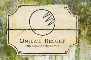 a sign for the entrance to an olive resort at Onilwe Resort Weligama in Weligama