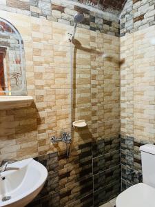 a bathroom with a sink and a glass shower at Wanas Kato Guest House in Shellal