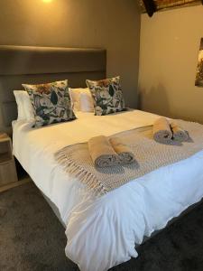 a bed with towels and pillows on it at Jock of the Bushveld in Barberton