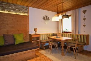 a living room with a couch and a table at Ferienhaus Gapp in Elmen