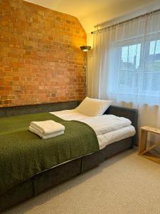 a bedroom with a bed against a brick wall at Red Brick House in Yeovil