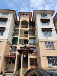 a tall apartment building with a car parked in front of it at Thetamu Homestay مسلم Pesona in Jalan Baharu