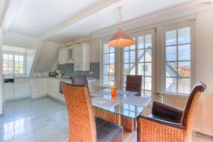 a kitchen with a dining room table and chairs at Abaco 2N in Wenningstedt