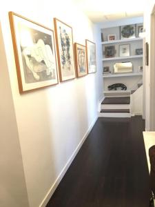 a hallway with pictures on the walls and a staircase at Duplex d'exception avec terrasse centre ville Montpellier in Montpellier