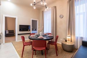 - un salon avec une table à manger et des chaises dans l'établissement Dandelion Apartments Ģertrūdes, à Riga