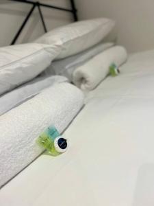 a row of white towels on a rack at The Orchard - Ground Floor Flat in Bristol