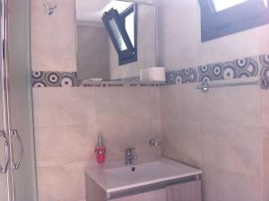 a bathroom with a sink and a mirror at Villa Soultana in Lindos