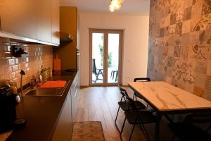 a kitchen with a sink and a table with chairs at Suite Vittoria in Ortona