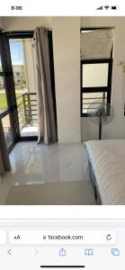 a picture of a bedroom with a bed and a window at Mikhaila Place is full in Iloilo City