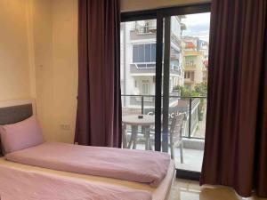 a bedroom with a bed and a view of a balcony at Rose 5 in Alanya +11 photos