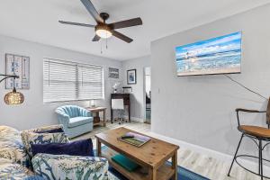 a living room with a couch and a table at Flagler Suites 2 in New Smyrna Beach