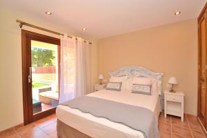 a bedroom with a white bed and a balcony at 066 Villa Mexic 41 ETV8816 by Mallorca Charme in Santa Margalida +27 photos