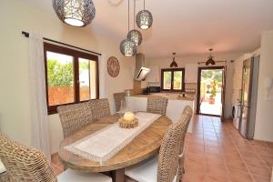 a kitchen and dining room with a wooden table and chairs at 066 Villa Mexic 41 ETV8816 by Mallorca Charme in Santa Margalida