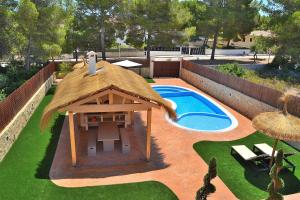 a backyard with a gazebo and a swimming pool at 066 Villa Mexic 41 ETV8816 by Mallorca Charme in Santa Margalida