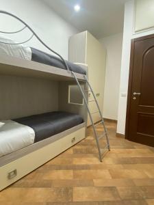 a bunk bed with a ladder in a room at Domus Melius in Castellammare di Stabia +4 photos