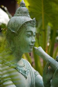 a statue of aitating woman holding a bat at Wave-F in Ko Kood