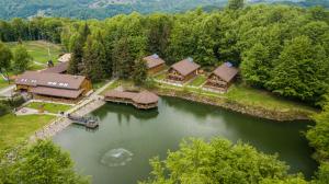 an aerial view of a house on a river at Suior Resort Cota 1000 in Baia-Sprie +21 photos