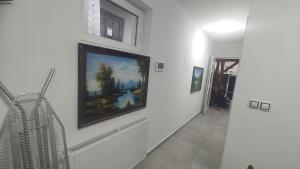 a hallway with a painting on the wall at Vu's Home in Prague