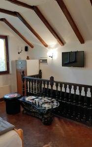 a living room with a table and a tv at Apartman Kamen 1 in Negotin