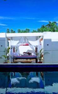 a white pavilion with a pool in front of it at Villa Noblezza in Las Lagunas