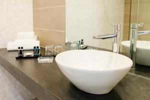a bathroom with a white bowl sink on a counter at Arribas Sintra Hotel in Sintra