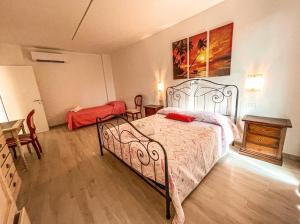 a bedroom with a bed and a dresser and a table at AGRITURISMO LE GHIRLANDE in Valeggio sul Mincio +23 photos