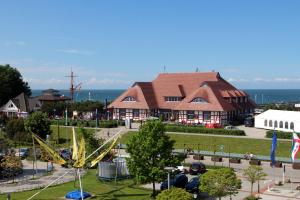 an amusement park with a building and a roller coaster at Kranich in Zingst