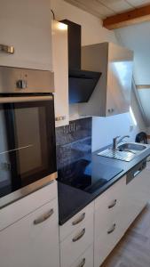 a kitchen with a sink and a counter top at Zum Holzwurm in Mühlanger