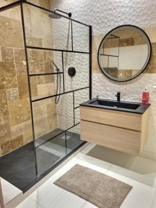 W łazience znajduje się umywalka i lustro. w obiekcie Appartement T2 40m2 Rénové Au Coeur du Panier Vieux Port w Marsylii