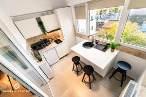 an overhead view of a kitchen with a counter and stools at Central Residence Apartment 505 in Bucharest