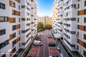 an aerial view of a parking lot between two tall buildings at Central Residence Apartment 505 in Bucharest