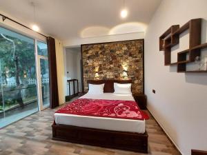 a bedroom with a bed with a red blanket at Nine Arch Gap in Ella