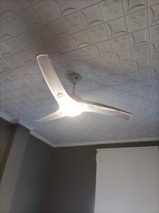 a ceiling fan with a light on a ceiling at Habitación3 Villena lavanda in Villena