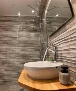 a bathroom with a white sink and a mirror at Μούσες in Kalavrita +36 photos