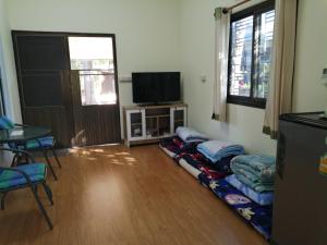 a living room with a bunch of pillows on the floor at Wasuthan Garden House in Nong Khai