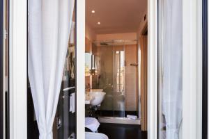 a bathroom with a sink and a toilet and a shower at Hotel Touring in Bologna +177 photos