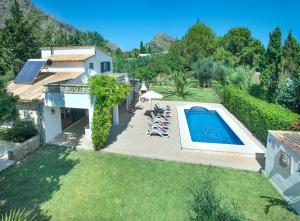 a backyard with a swimming pool and a house at Owl Booking Villa Bocoris - 15 Min Walk to the Beach in Port de Pollensa