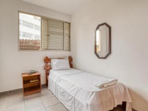 a small bedroom with a bed and a mirror at Hotel Itajubá Classic - Goiânia in Goiânia +17 photos