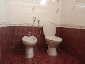 a bathroom with a toilet and a bidet at Pournami Home Stay in Trichūr